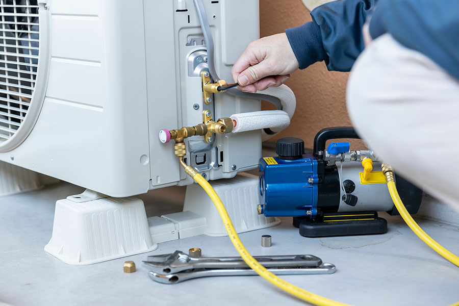 Technician fixing refrigerant leak
